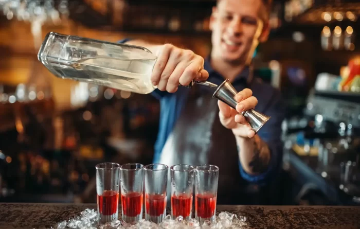 male-barman-in-apron-prepares-alcoholic-coctail.jpg